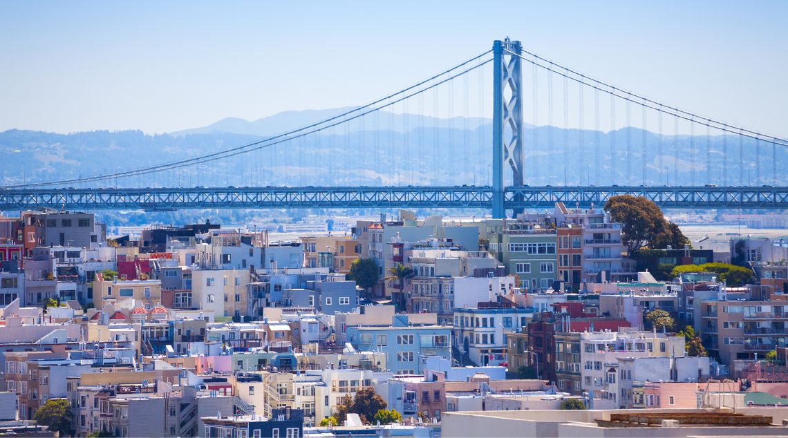 a view of the San Francisco Bay bridge over the city of buildings
